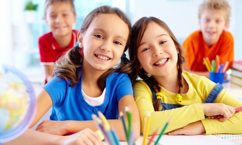 Two diligent girls looking at camera